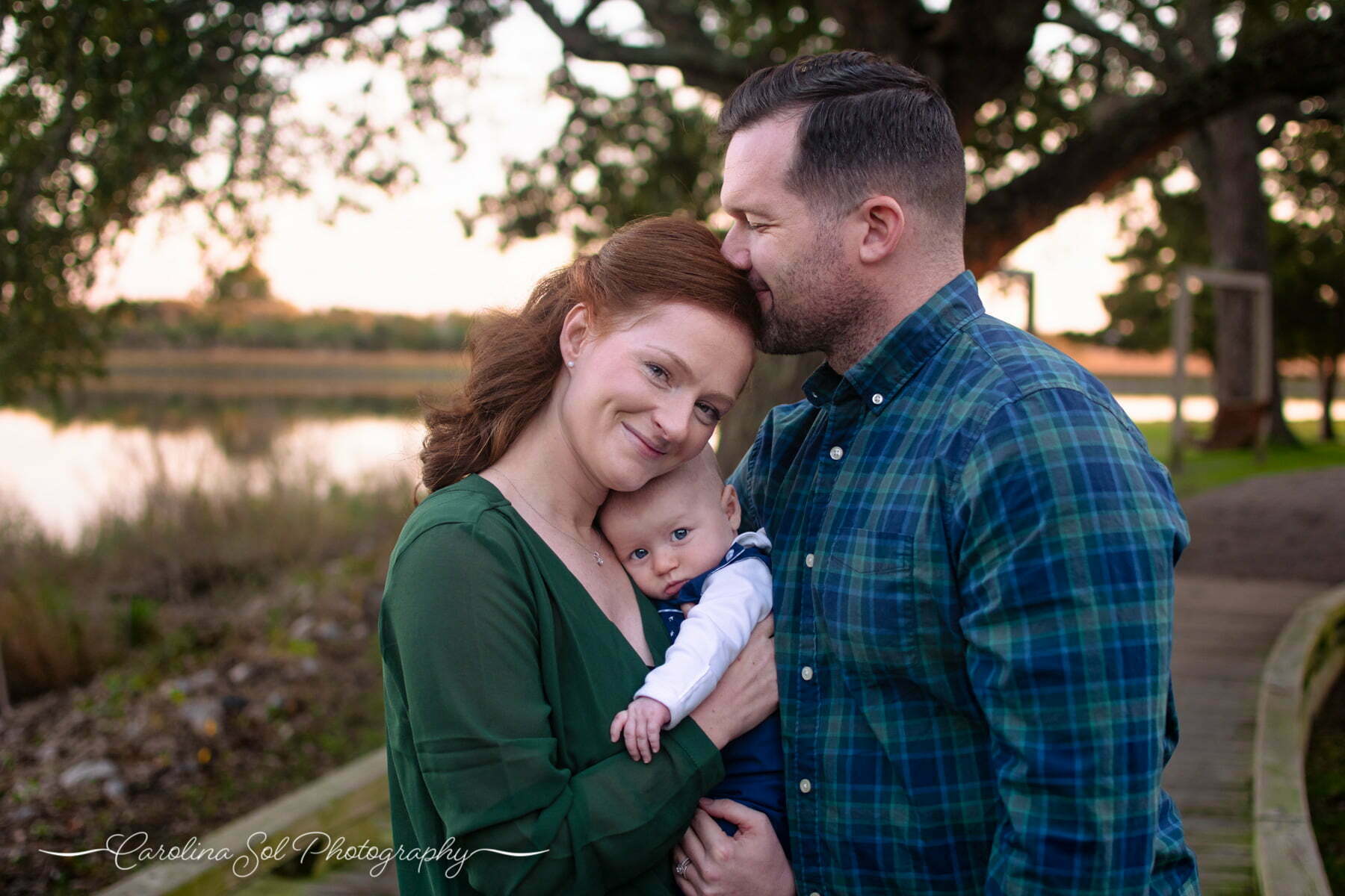 Lifestyle family photography session with newborn at sunset beach park.