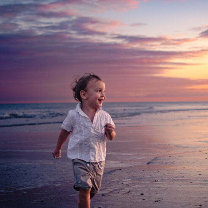 Candid portrait family photography Holden Beach NC colorful sunset.