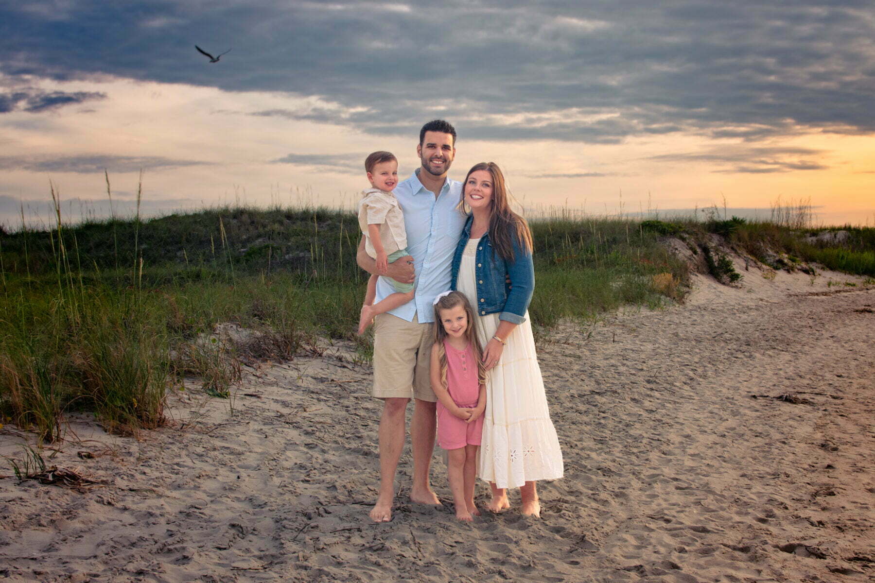 Lifestyle family photography session on Oak Island, NC beach at sunset.