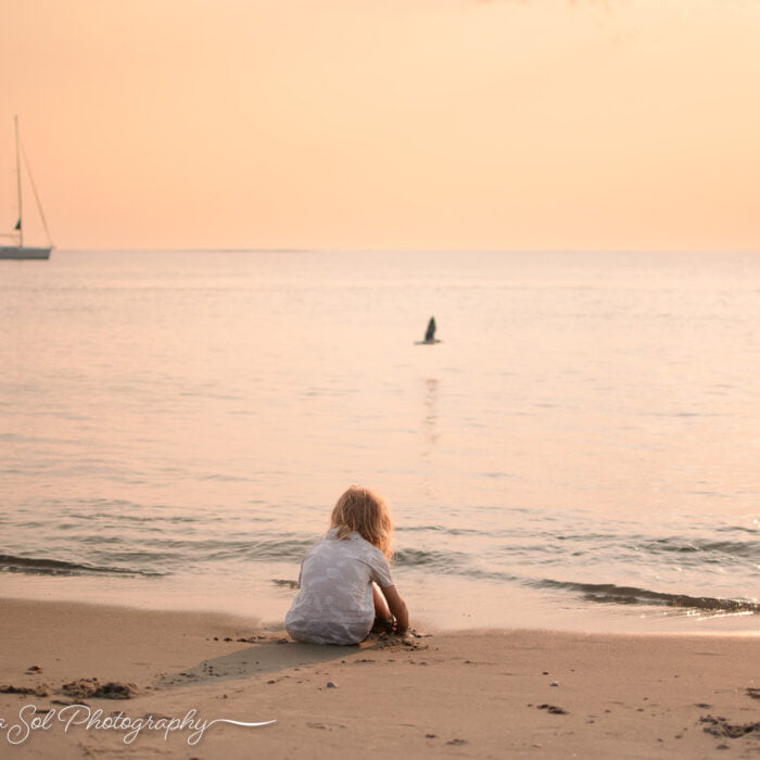 Bald Head Island, NC lifestyle family photographer with sailboat.