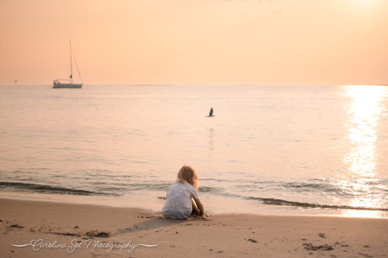 Bald Head Island, NC lifestyle family photographer with sailboat.