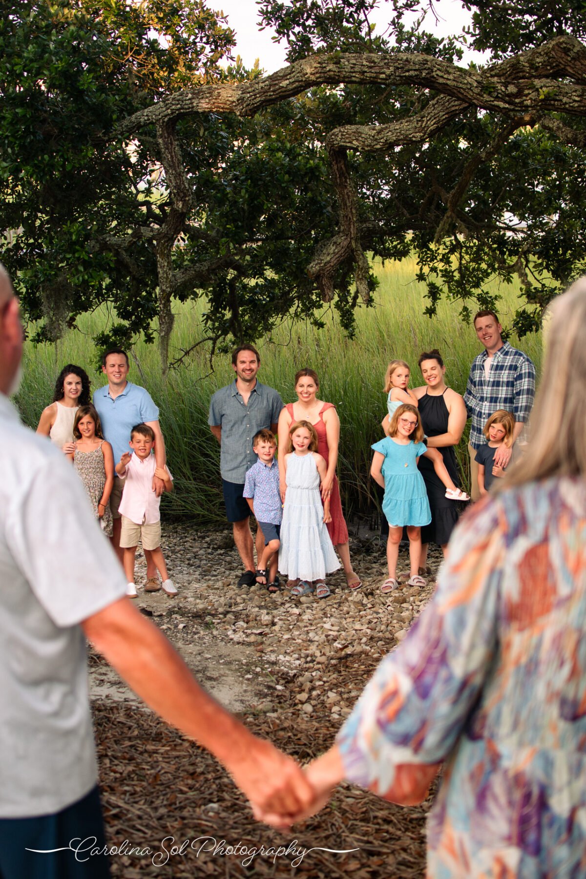 Extended family lifestyle portrait photography session under mossy oaks Sunset Beach, NC.